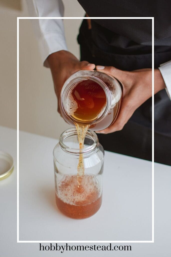 pouring strawberry flavored kombucha