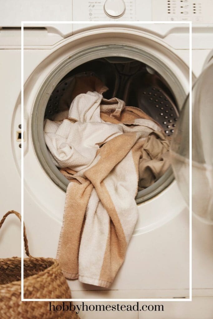 bath towels hanging out of a front load washer